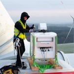 Ein ForWind-Wissenschaftler installiert das laseroptische Lidar-Messgerät zur Erfassung der Nachlaufströmung auf der Gondel einer Windenergieanlage der Firma eno energy.