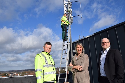 Christopher König bringt das LoRaWAN-Gateway und die Antenne auf dem Ibbenbürener Rathaus an.